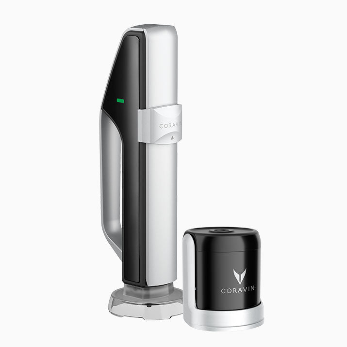 Coravin wine preservation system featuring a sleek silver and black design with a green indicator light and brand logo.