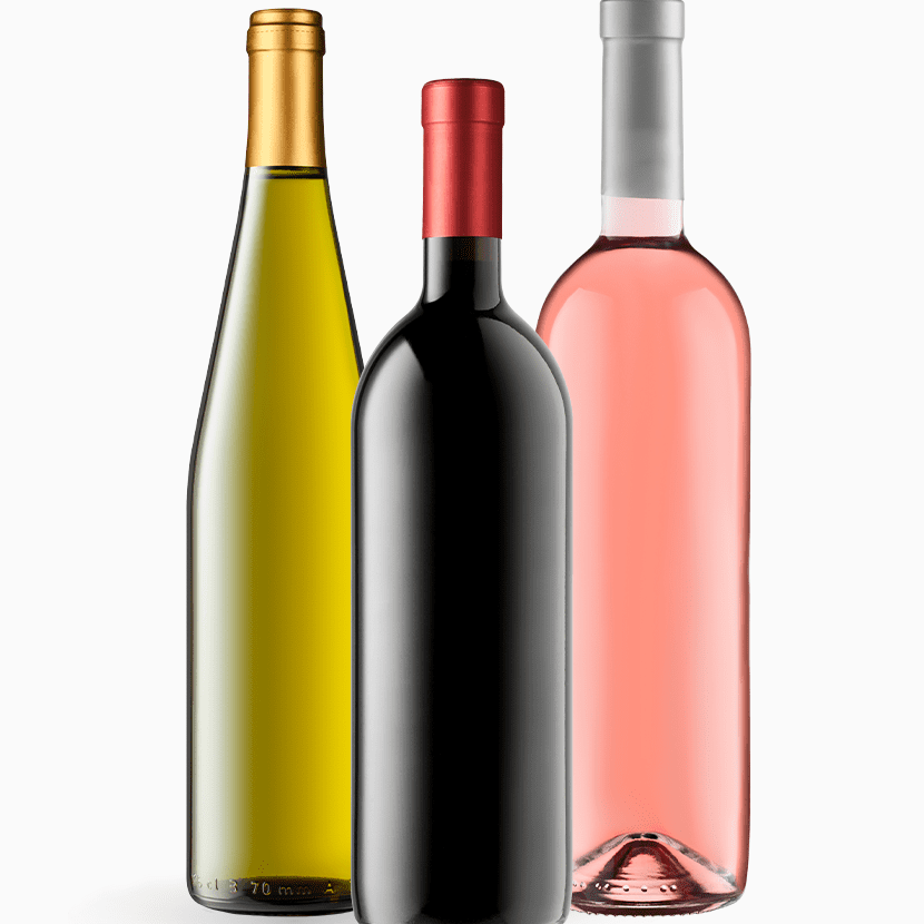 Three wine bottles: a green bottle with a gold cap, a black bottle with a red cap, and a pink bottle with a silver cap.