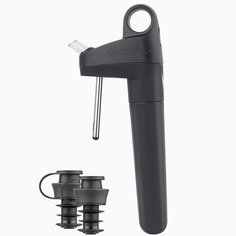 Coravin wine opener in black with two black wine stoppers, designed for preserving wine after opening.