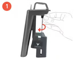Instruction step one illustrating a hand using a tool to turn a screw on a device with a handle and a base labeled "Coravin."