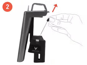 Step 2: A hand placing a small item onto a black device holder from a side view.