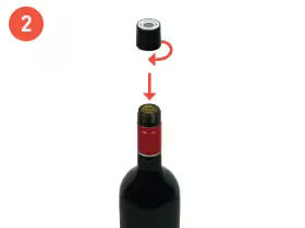 Step 2: Removing the black cap from a wine bottle top, with an arrow indicating the motion.