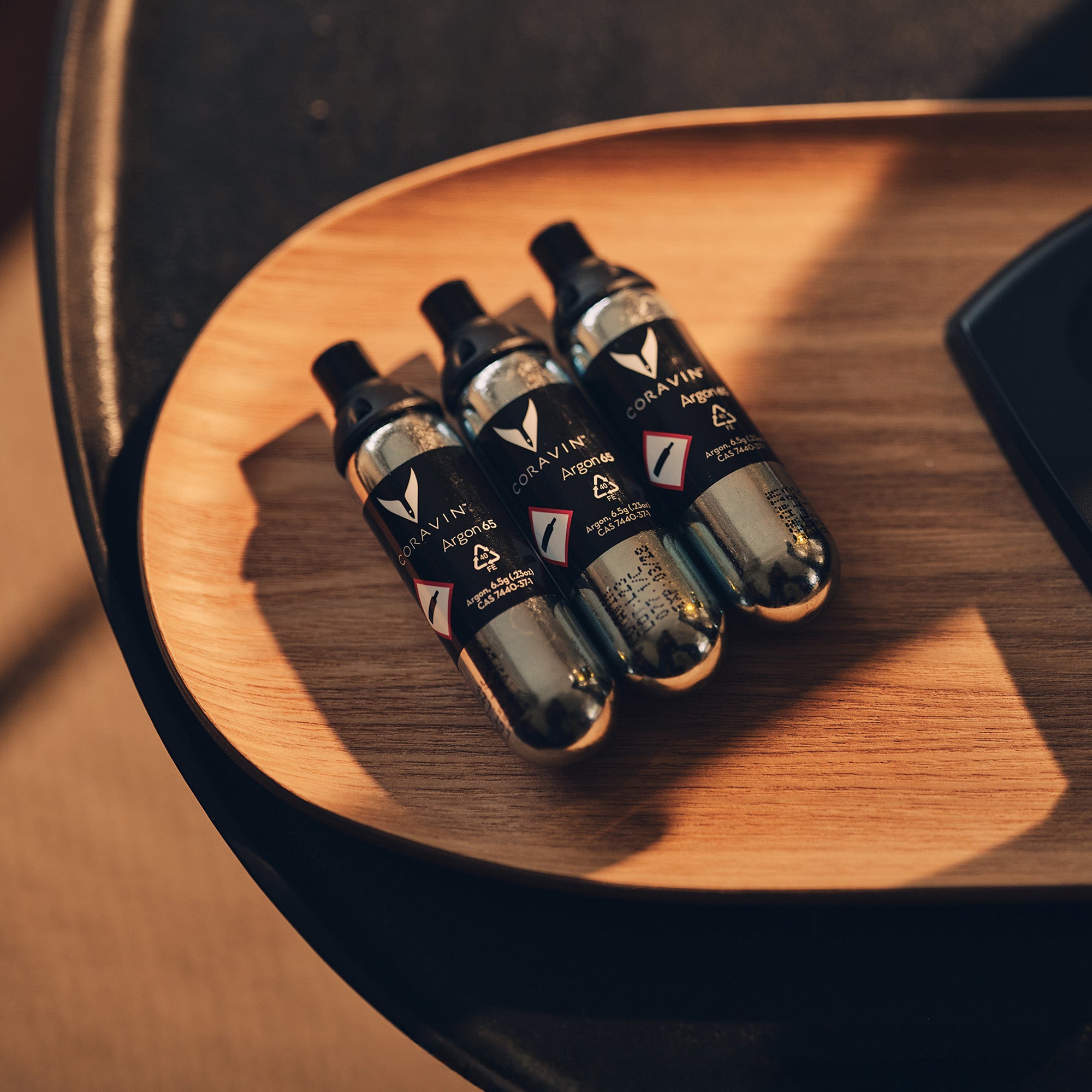 Four capsules with visible Coravin branding on a wooden surface